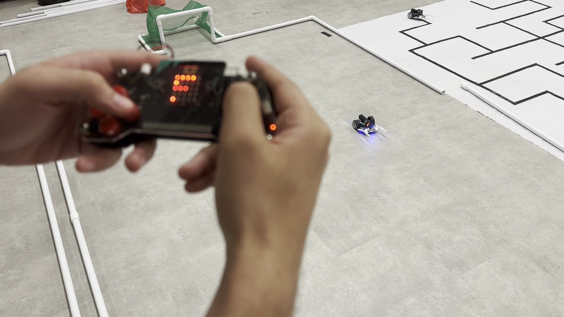 A blurred image of a preson controlling a robot.